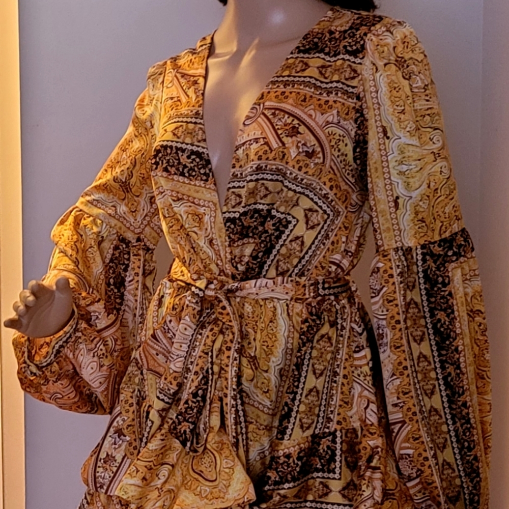 This a luxxel dress large in size, orange with brown prints in color
